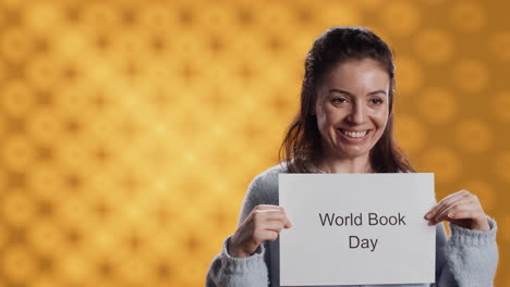 smiling book club member holding placard with world book day message