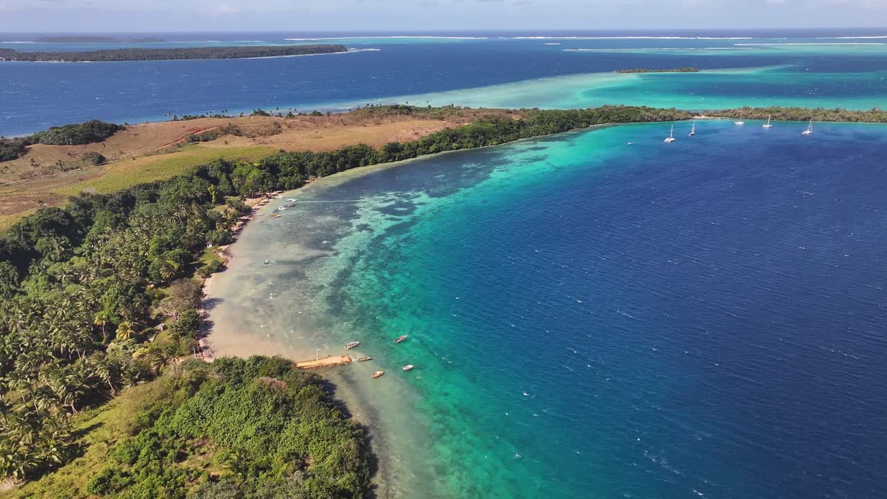 Vava'u, Tonga - A Picturesque Scene of an Island Framed by Vibrant Turquoise Waters and Dense, Tropical Greenery - Aerial Pullback Shot