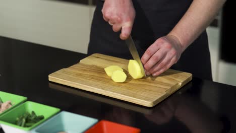 chef cutting potatoes