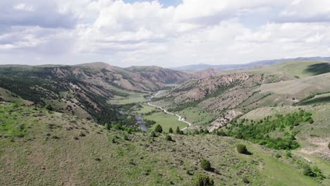 Idaho-Green-Mountains-and-Canyons-in-the-Summer-with-Cloudy-Sky-Aerial-View-4K