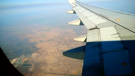 airplane fly over barren area