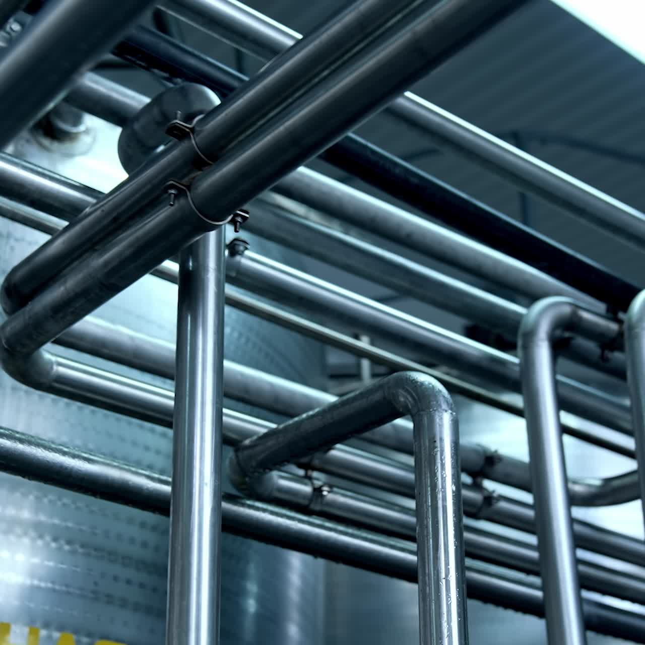 Modern sterilized milk production factory. Industrial organic food making process