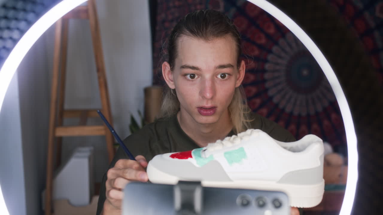 Young Designer Vlogging about Custom Sneakers on Smartphone