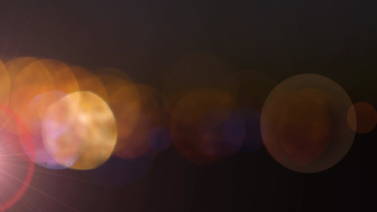 puntos de luz brillantes de color naranja contra un fondo negro