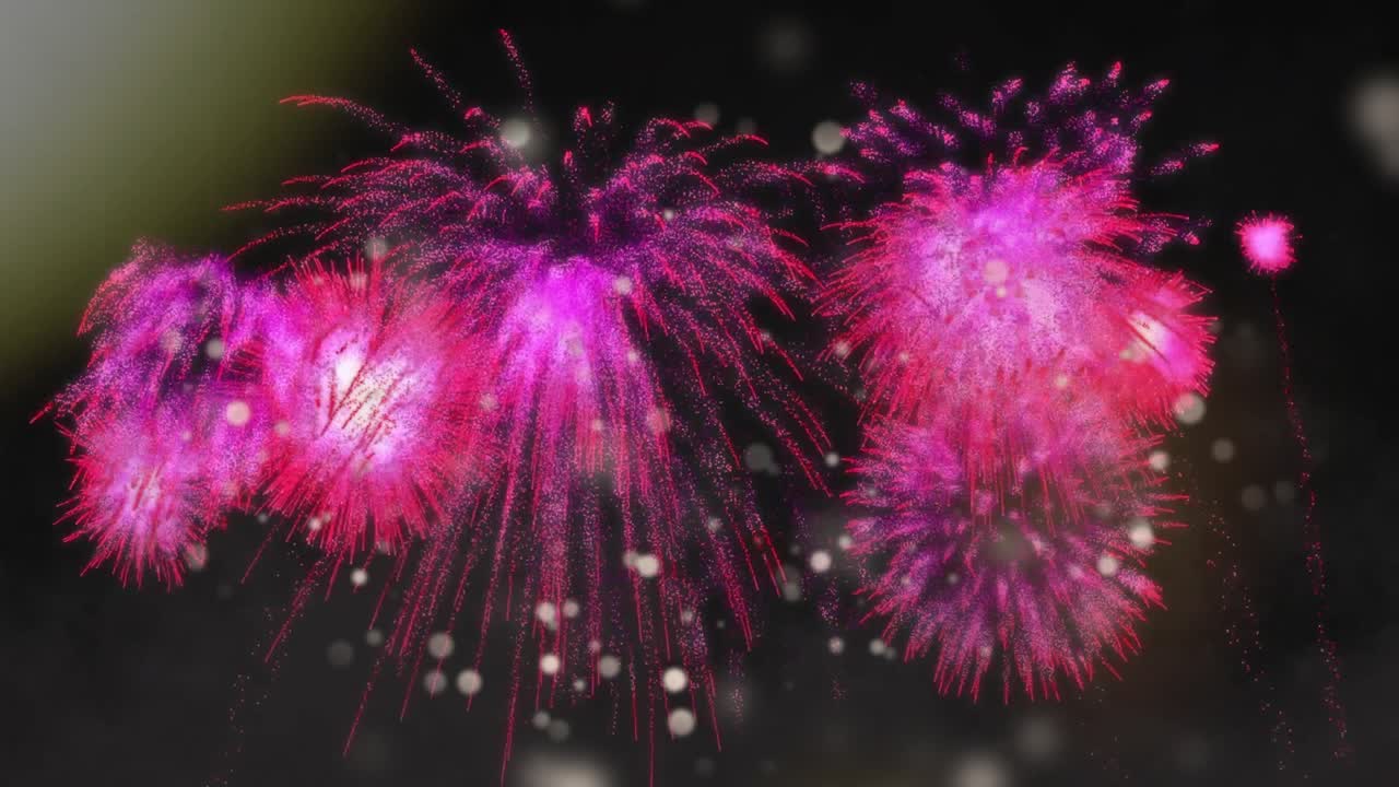 Animation af lyskugler over lyserødt fyrværkeri på sort baggrund.