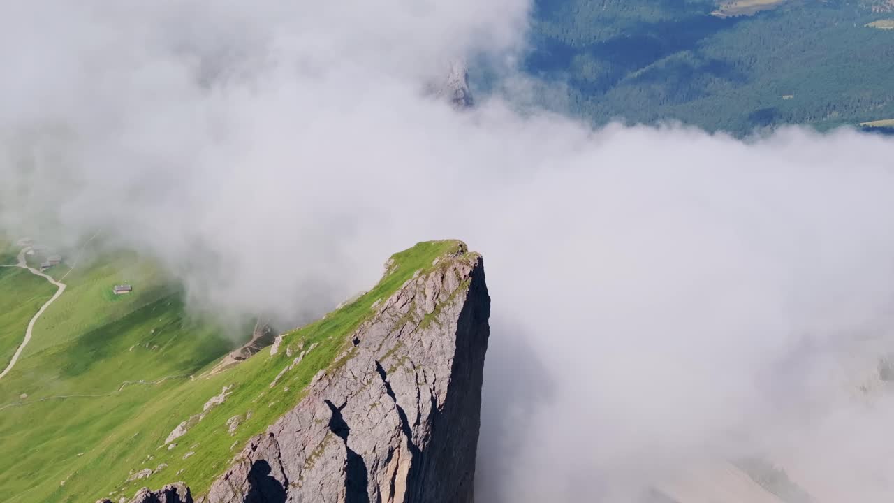 Peaceful nature drone shot showing harmony between earth clouds and mountain top