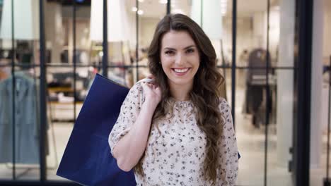 video portrait of beautiful woman with shopping bags in mall