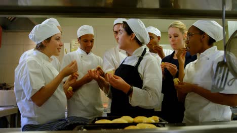 chefs testing cookie in kitchen 4k