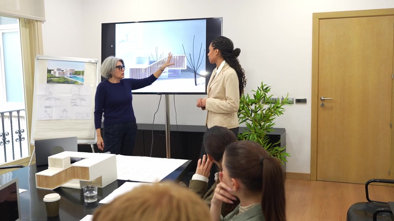 Professional Architects Presenting Architectural Designs in a Conference Room