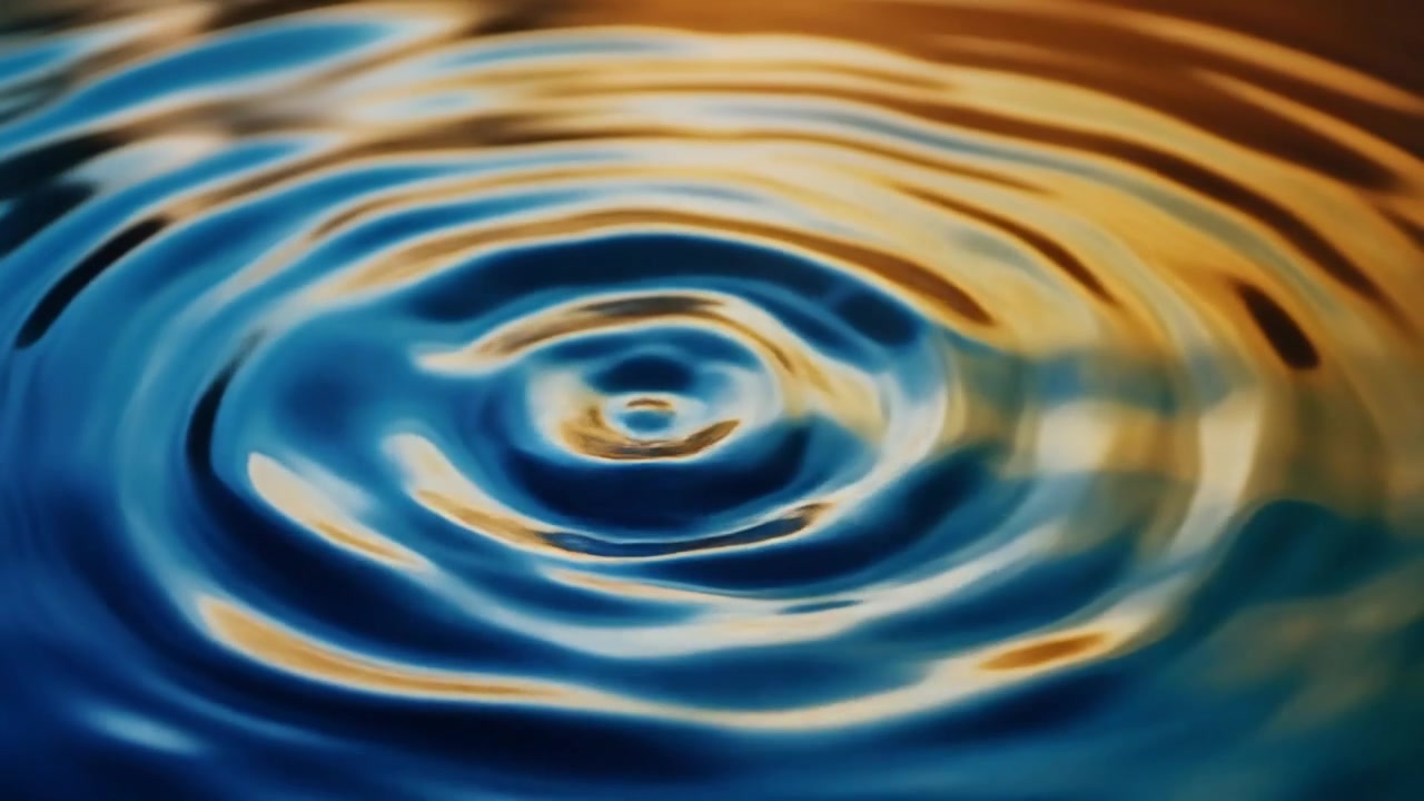 Single Water Drop Creating Concentric Ripples on Liquid Surface