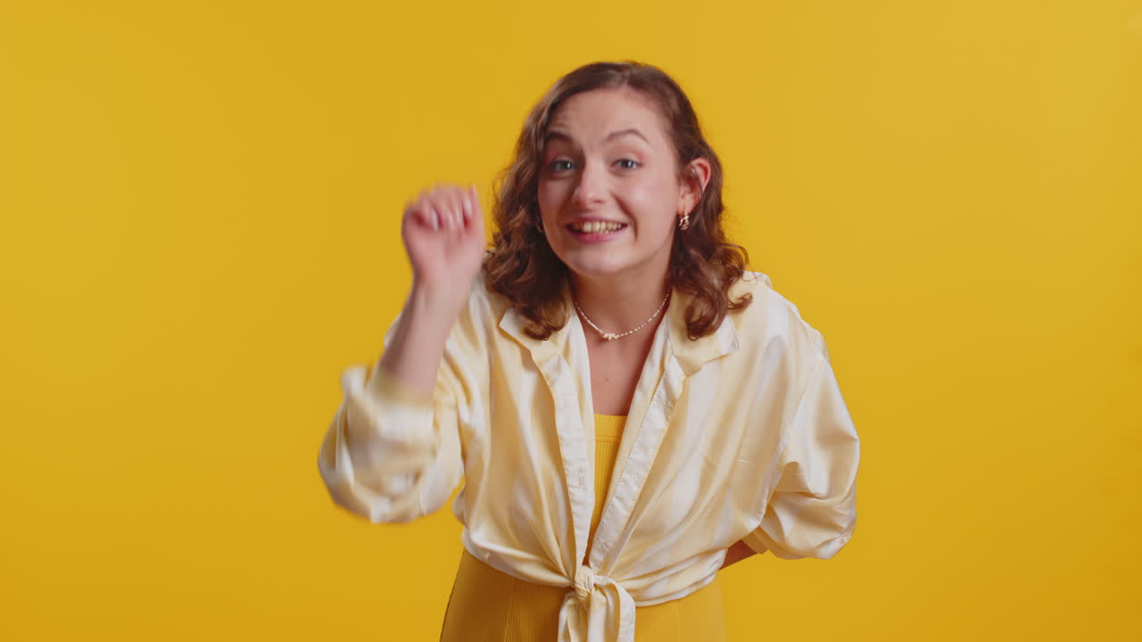 Excited young woman knocking door gesture asking who is at home feeling embarrassed no idea