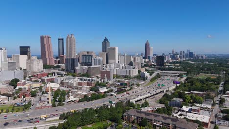 drone shot pulling out from the downtown atlanta and midtown skyline on a summer day