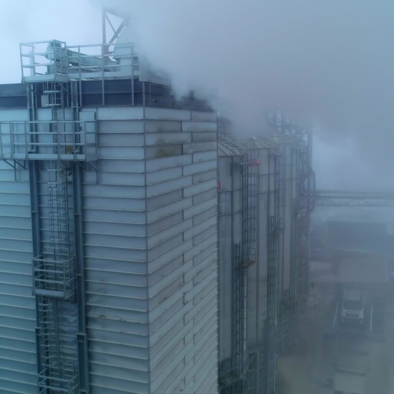 Drone shot of industrial grain elevator. Granary big construction storage
