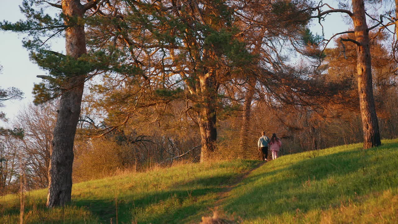 Young friends running on nature background in autumn. Happy couple having a scamper in the forest in the morning.
