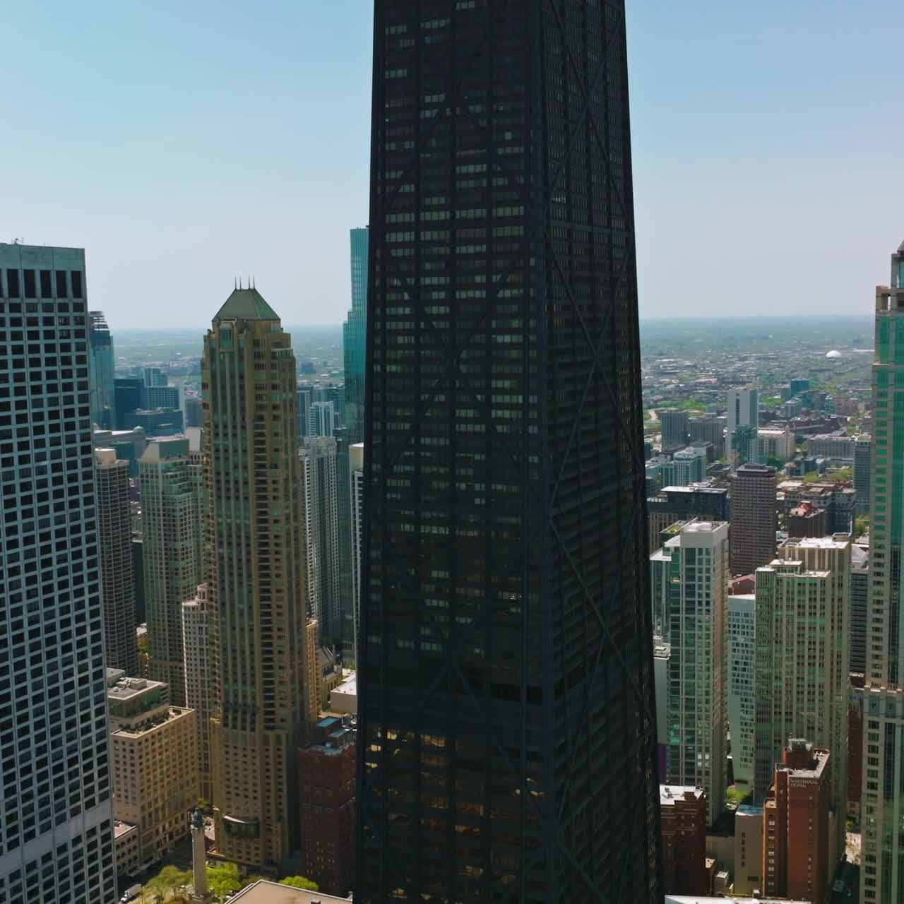 Skyscrapers of amazing Chicago. Drone shot rising along the outstanding city against blue sky backdrop