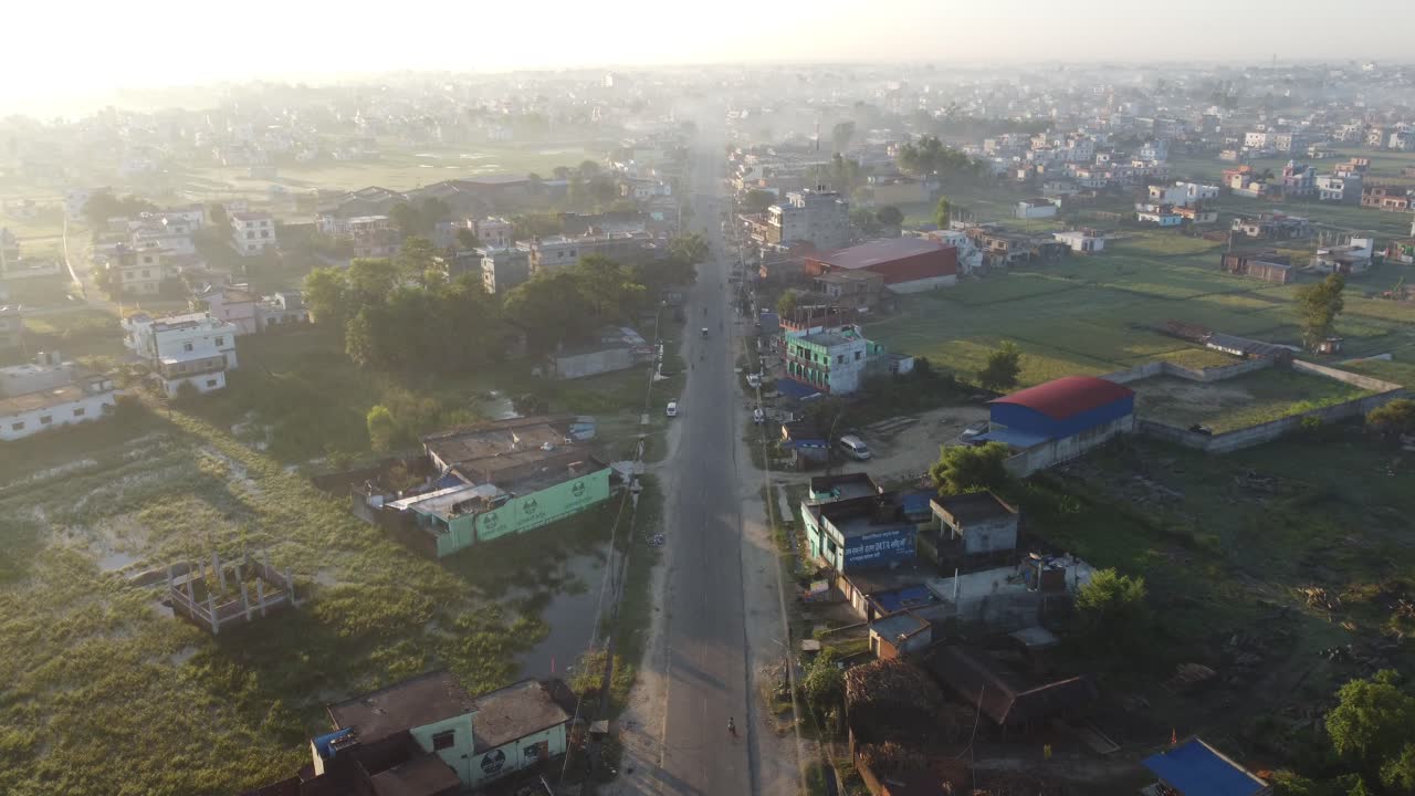 An aerial view of a straight road bordered by houses in the town of Nepalgunj