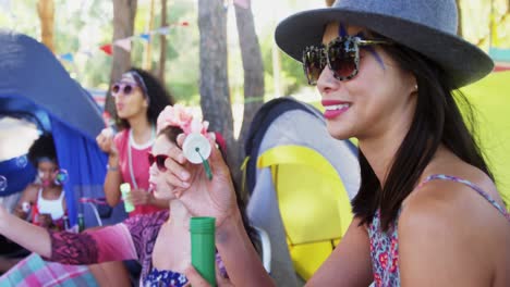 group of friends blowing bubbles at music festival 4k