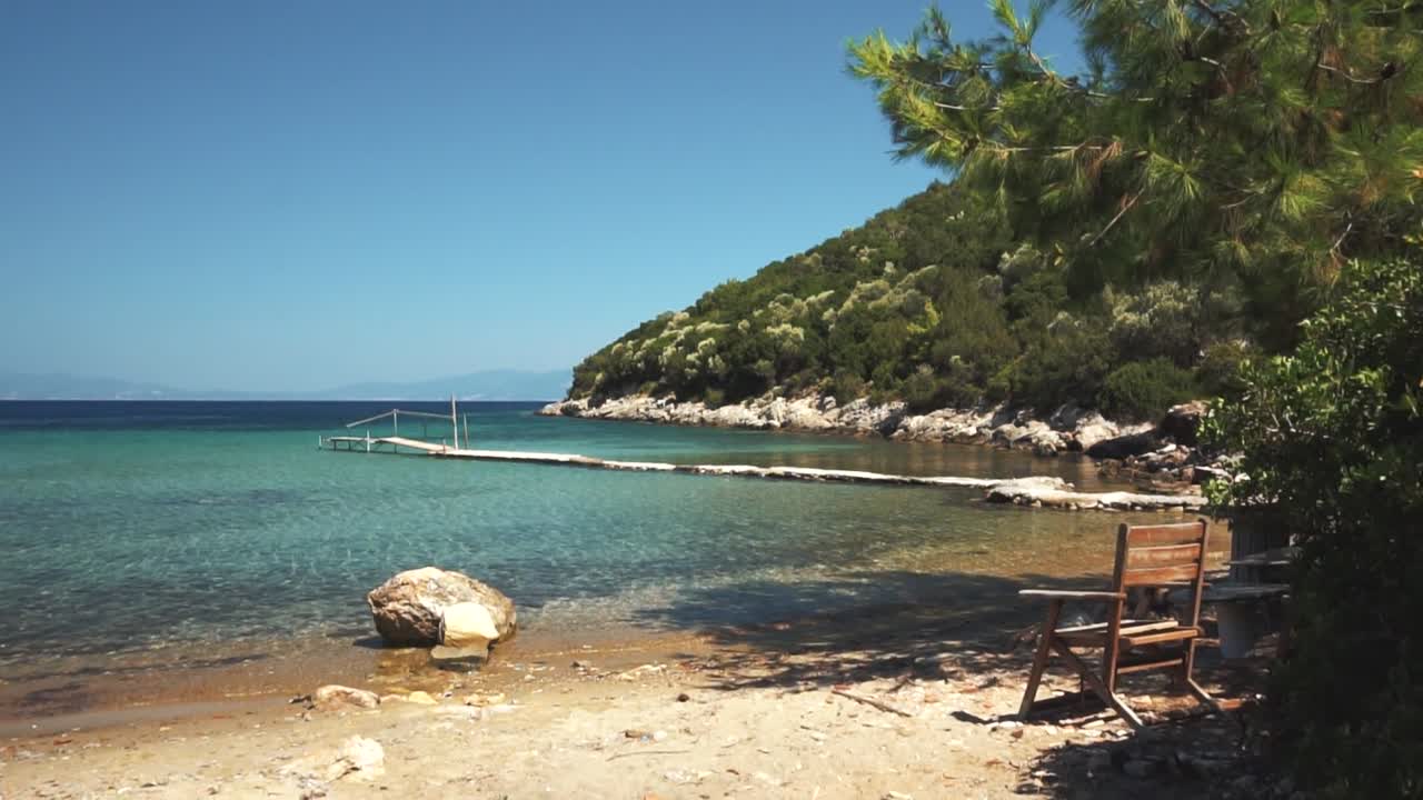 Beautiful Beach Scene with Pier and Wooden Chair