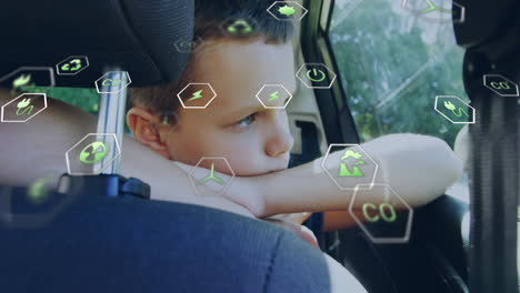 child resting in car seat with green energy icons overlay animation