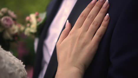 the bride strokes the groom's hand