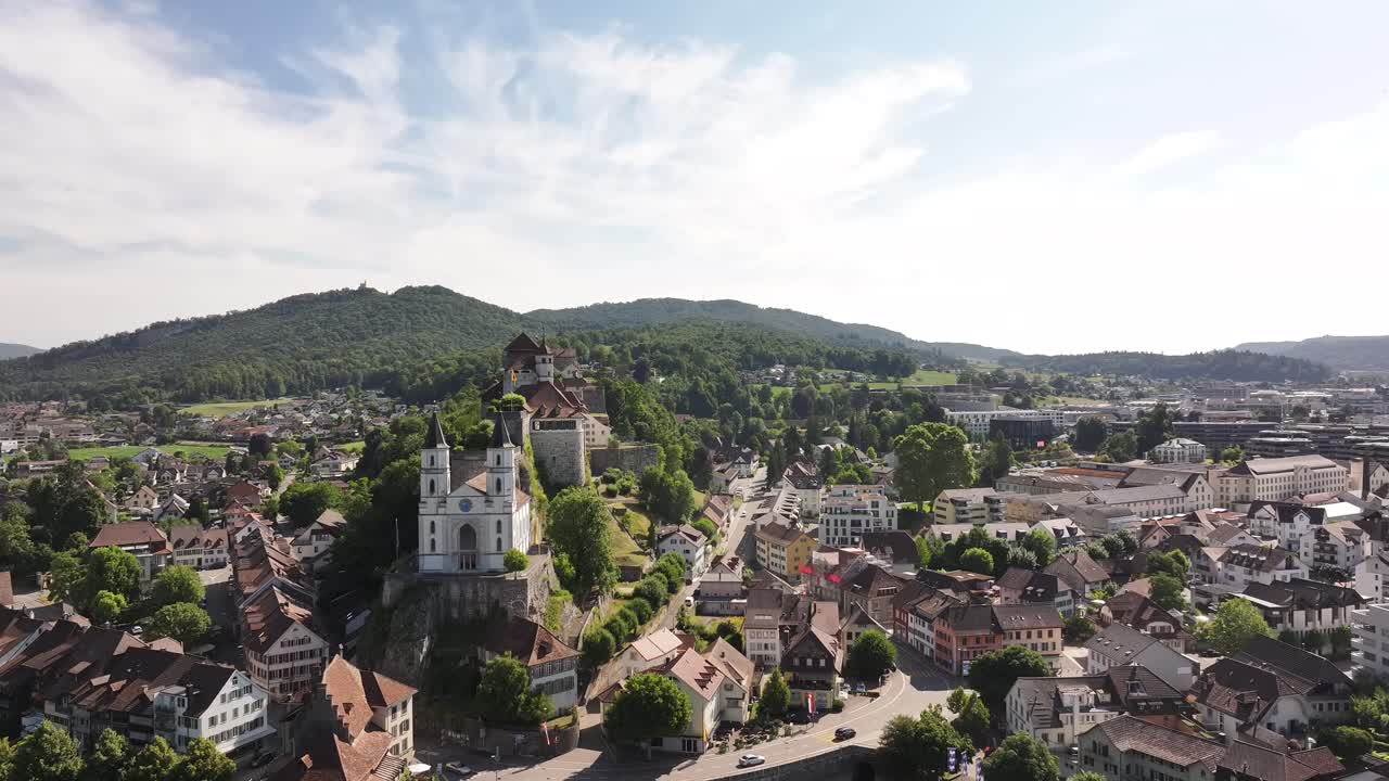 Aarburg Castle and white church above Aare river in Canton Solothurn, Switzerland, drone view on sunny summer day