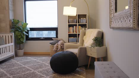 nursery rocking chair in a modern infant room with a crib in a condo