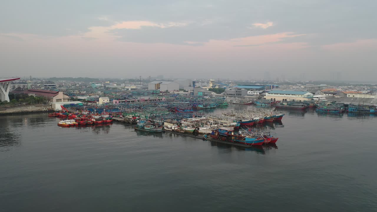 Fishing boats in a port at sunrise/sunset