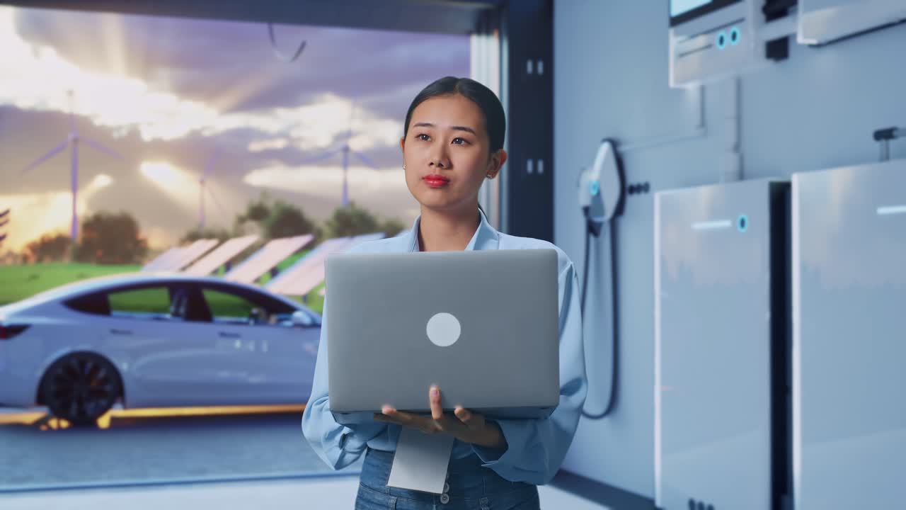 Asian Female With Her Laptop With Home Energy Storage System In a Modern Garage, She Observes By Looking Around Before She Come To Concentrating With Her Laptop