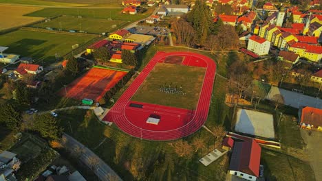 aerial 4k drone footage of outdoor sports complex and the group of people involved in physical activity