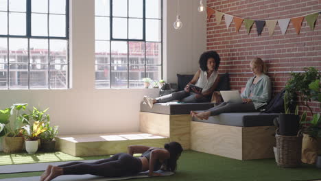 young-business-woman-doing-yoga-meditation-enjoying-mindfulness-exercise-cobra-pose-relaxing-in-modern-office-workplace-on-lunch-break