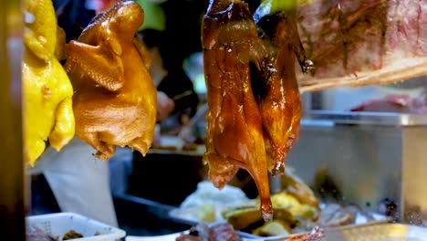 roasted ducks hanging in a hong kong market