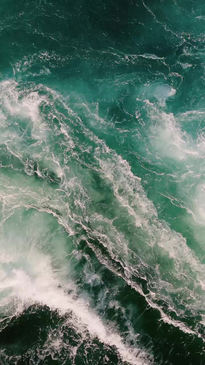 Blue waves of water of the river and the sea meet each other during high tide and low tide.