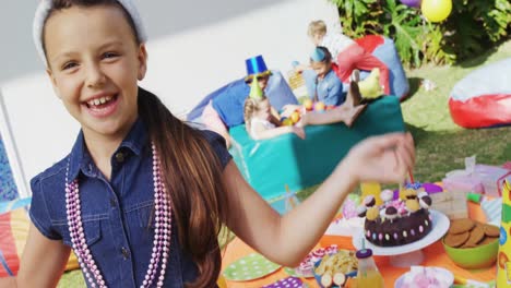 Portrait-of-smiling-girl-with-arms-raised-during-birthday-party-4k