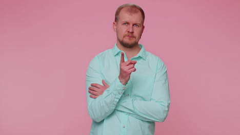 displeased man shakes finger, saying no, be careful, scolding, giving advice to avoid danger mistake