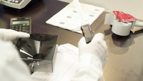 worker measuring dimensions of a plastic product with a digital caliper