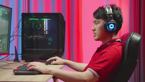 excited man making winner while playing survival shooter games on computer