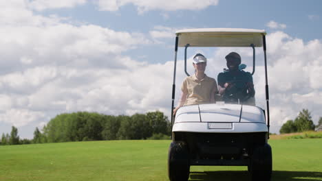 caucasian woman and african american man on the golf course.