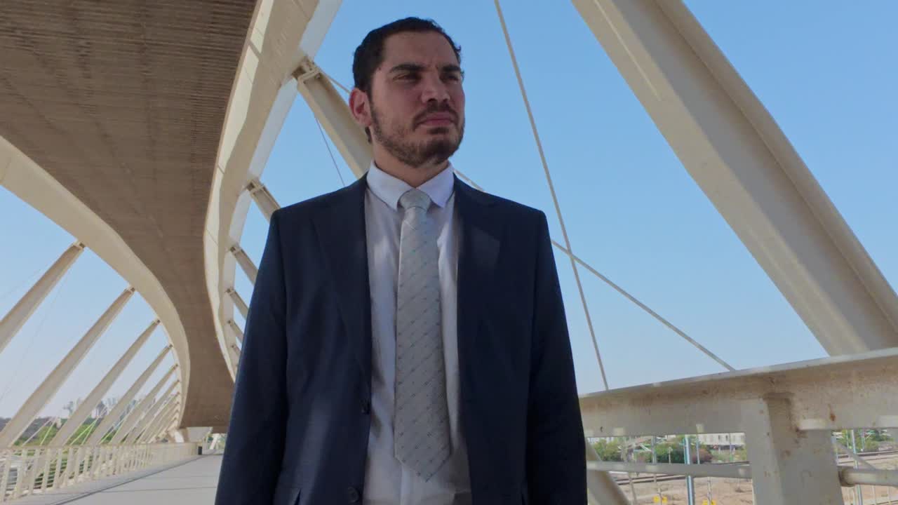 Low Angle View of a Confident Businessman Standing on a Modern Bridge