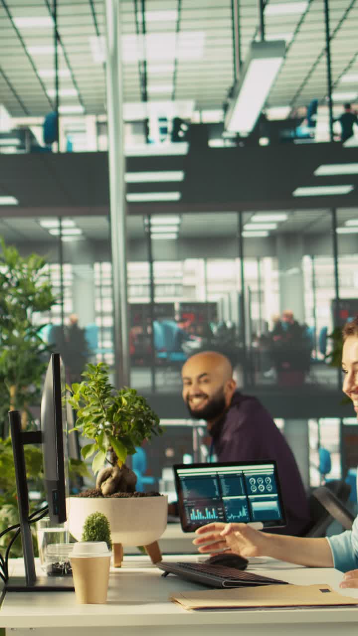 Vertical video Happy employee starts first day at job, unpacking belongings, meeting coworkers