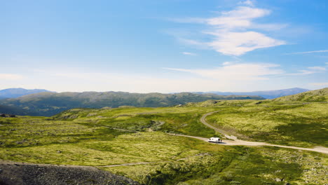 camper van positioned on the roads of green mountains at rondane national park in norway