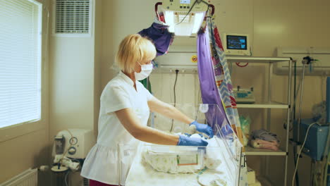 nurse caring for a newborn in a neonatal intensive care unit