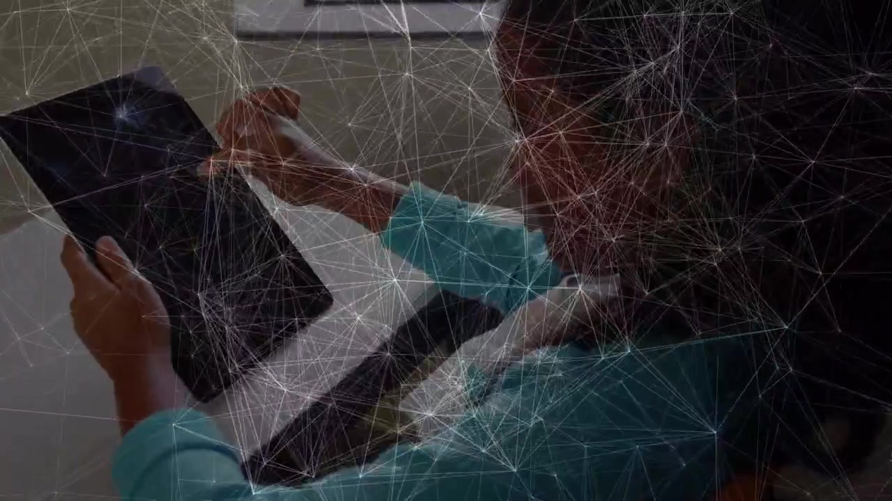 Animation of network of connections over indian girl using digital tablet in the class at school