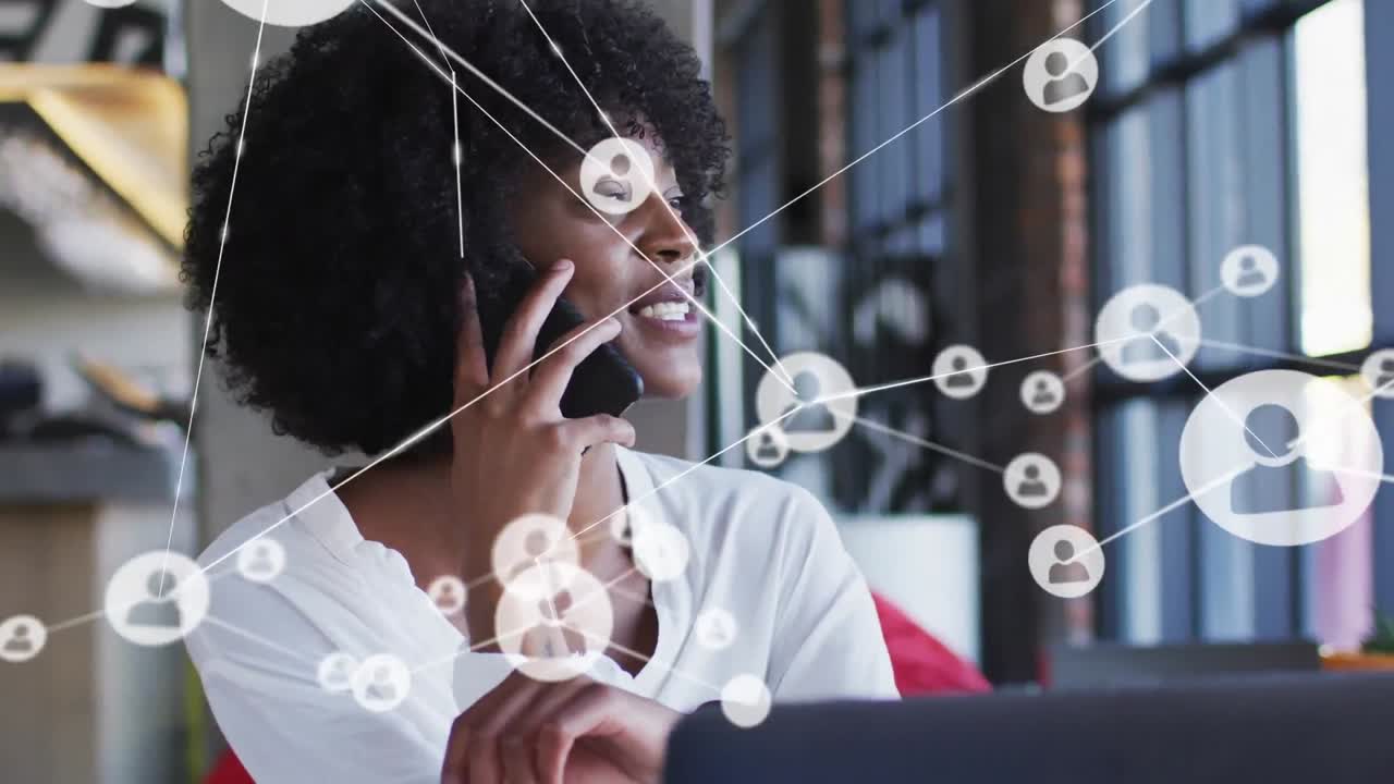 Animation of network of connections over african american businesswoman talking on smartphone