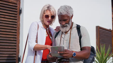 mature couple using a map during their vacation