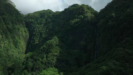 faarumai waterfall falls valley tahiti french polynesia aerial drone vaimahuta fall tiarei hitiaa o te ra watershed picturesque river cascades trees forest jungle daytime sunny blue sky forward reveal