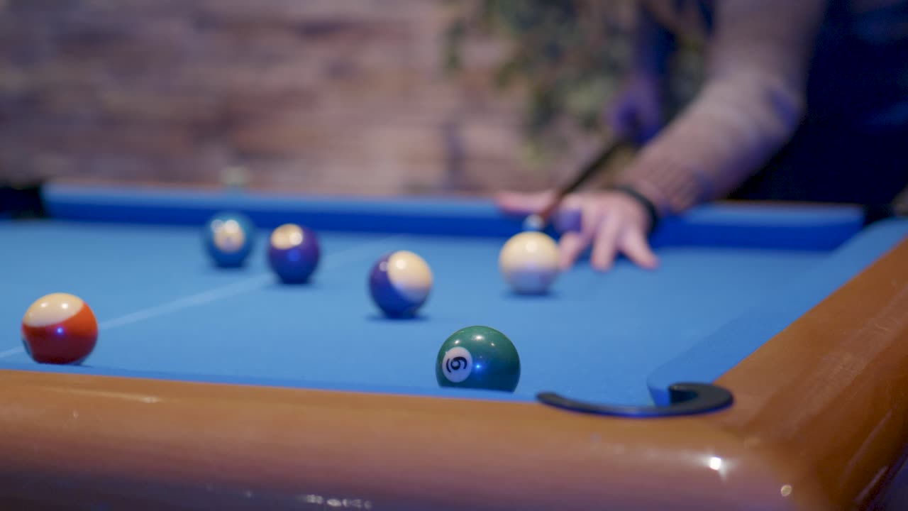 Pool table player targeting ball number six