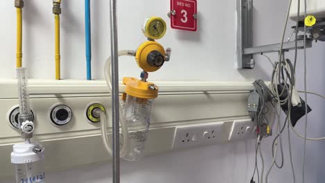 closeup of bed head panel in icu its a centralized hub for medical vital healthcare equipment like vacuum suction, oxygen supply, electrical outlets, and communication systems