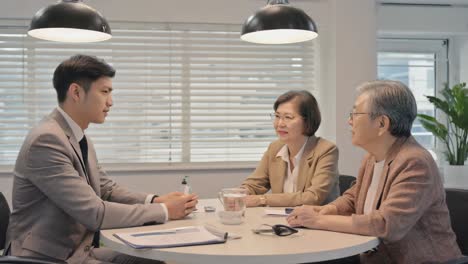 business meeting or financial consultation with a young professional and elderly clients
