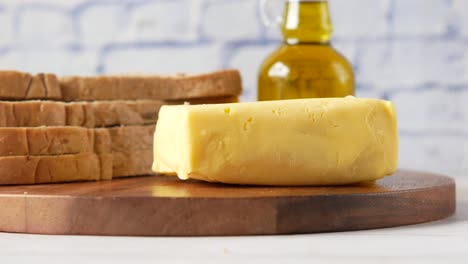 butter and bread on a wooden board