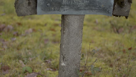 tilting over old and broken crucifix at graveyard